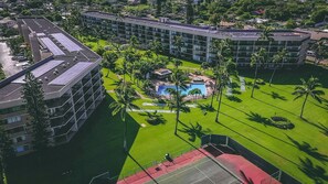 A hotel with multiple buildings, a central pool area, and surrounding greenery. - Maui Sunset Vacation Rentals B219 (Kihei)