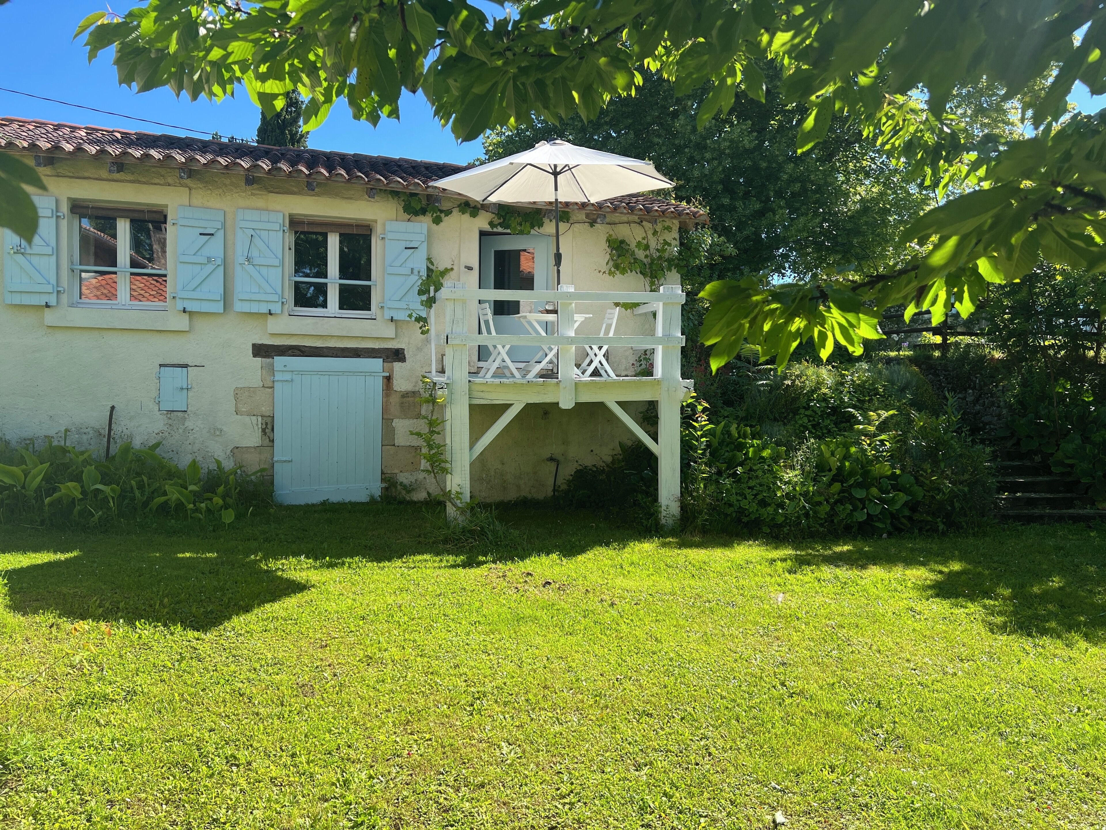 A house with a balcony, a door, and a window.