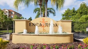 A sign with the name "ENCANTADA" and a water fountain in front.