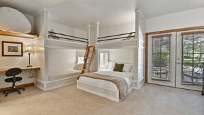 A bunk bed room with a desk and chair, a ladder, and a view of the outdoors through a sliding door. - Family Getaway~pool, Tubing, Skiing, & Ice Castles Villa 1002 1 Bedroom Villa by RedAwning (Midway)