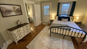 Un dormitorio con cama, cómoda y un cuadro en la pared.
