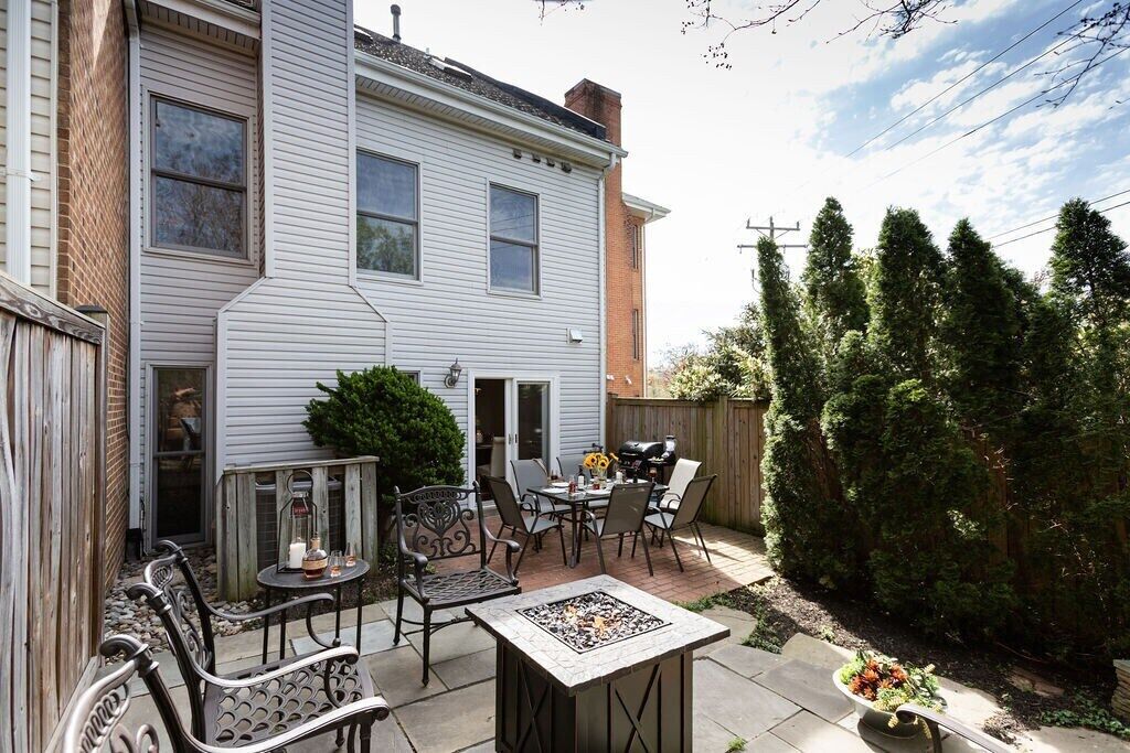 A patio with outdoor furniture, a fire pit, and a barbecue grill.