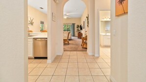 A hallway leading to a dining area with a kitchen, a tiled floor, and a ceiling fan. - Bahama Bay third floor unit close to Disney (Davenport)