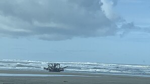 A beach with a large cloud in the sky and waves crashing onto the shore. - Remote Worker? Retired? Storm Tracker? +Own Canal Dock (Ocean Shores)