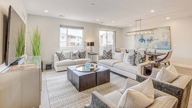 A modern living room with a sofa, coffee table, and chairs. There is a TV on the left and a painting on the wall. - Private Spa and Balcony Fire Pit With Mountain Views (Washington)
