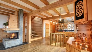 A wooden interior with a fireplace, a staircase, and a dining area. - Gorgeous home in Huba with house a mountain view (Huba)