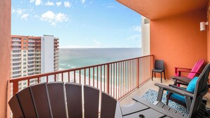 A balcony with a view of the ocean, a chair, a small table, and a red chair. - Shores of Panama Unit 2107~3 bedroom 3 bath~Sleeps 8 (Panama City Beach)