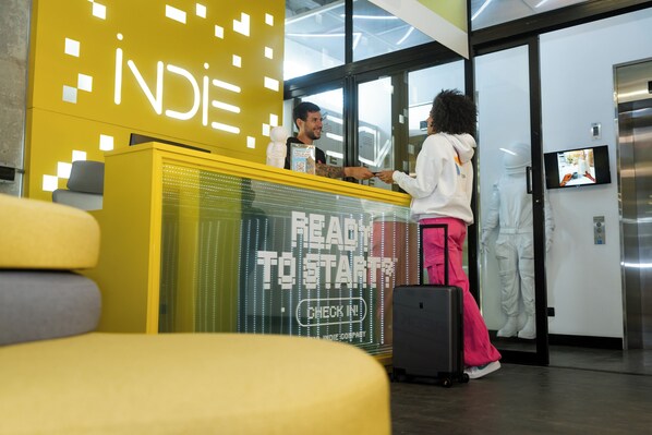 A reception area with a 'Ready to Start' sign, a digital display, and a television screen.