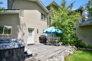 A house with a wooden deck, a hot tub, and a covered grill area. - Family Getaway~hot Tub, Ice Castles & Tubing Hs 5 Bedroom Home by RedAwning (Midway)