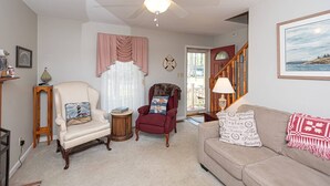 A living room with a ceiling fan, two armchairs, a sofa, a lamp, and a framed picture on the wall. - Coastal Colonial Charm located in Ocean Pines, MD by Karsons Keys (Ocean Pines)