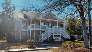 A two-story house with a front porch, a staircase, and a mailbox. - Pawleys Island Fairway Retreat 3BR Villa (Pawleys Island)