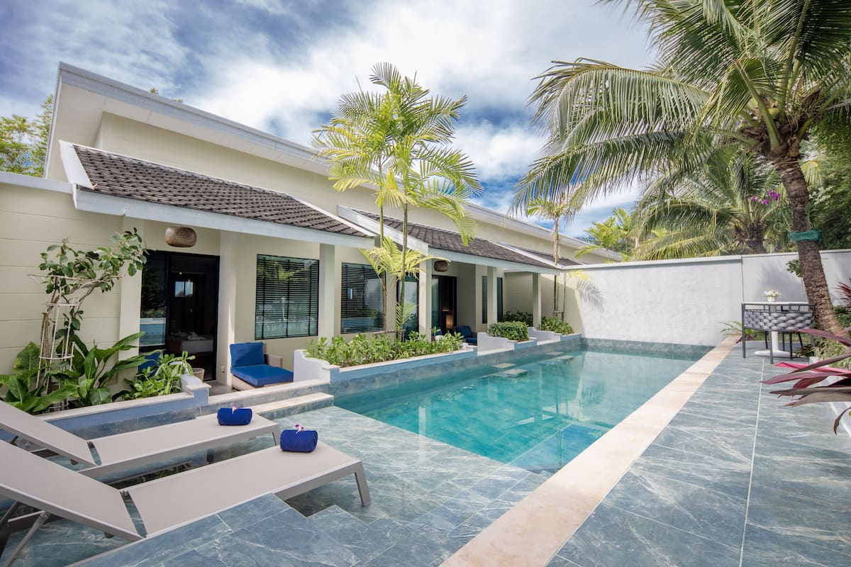 A modern pool area with lounge chairs and a clear pool.