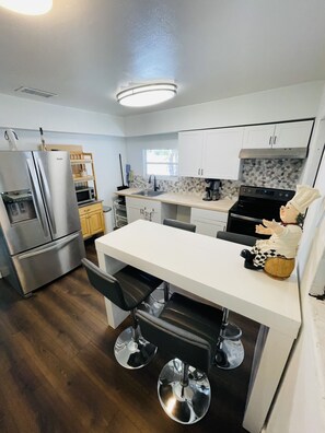 Enjoy cooking in this well-equipped kitchen with a central island and bar stools.
