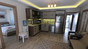 A compact living space with a kitchenette, a dining area, and a bedroom. - NEW LISTING! BEAUTIFUL 4 BEDROOM ALL EN-SUITE VILLA IN GULPINAR AREA OF DALYAN!! (Dalyan)
