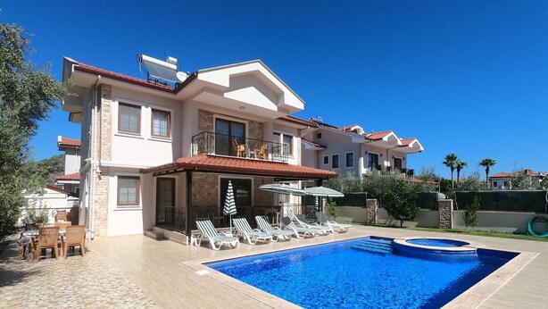 A two-story house with a swimming pool, outdoor seating, and a covered patio area. - NEW LISTING! BEAUTIFUL 4 BEDROOM ALL EN-SUITE VILLA IN GULPINAR AREA OF DALYAN!! (Dalyan)