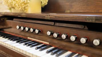 A close-up of a piano with keys and control knobs.