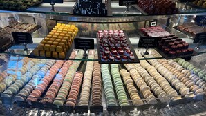 A bakery display with various pastries and desserts.