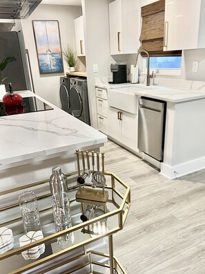 Enjoy cooking in this kitchen with a sleek countertop, oven, and dishwasher.
