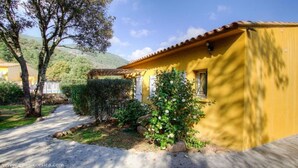 A yellow building with a tiled roof, surrounded by greenery and a pathway. - Quiet Villa n°2 near Porto Vecchio (San Gavino di Carbini)