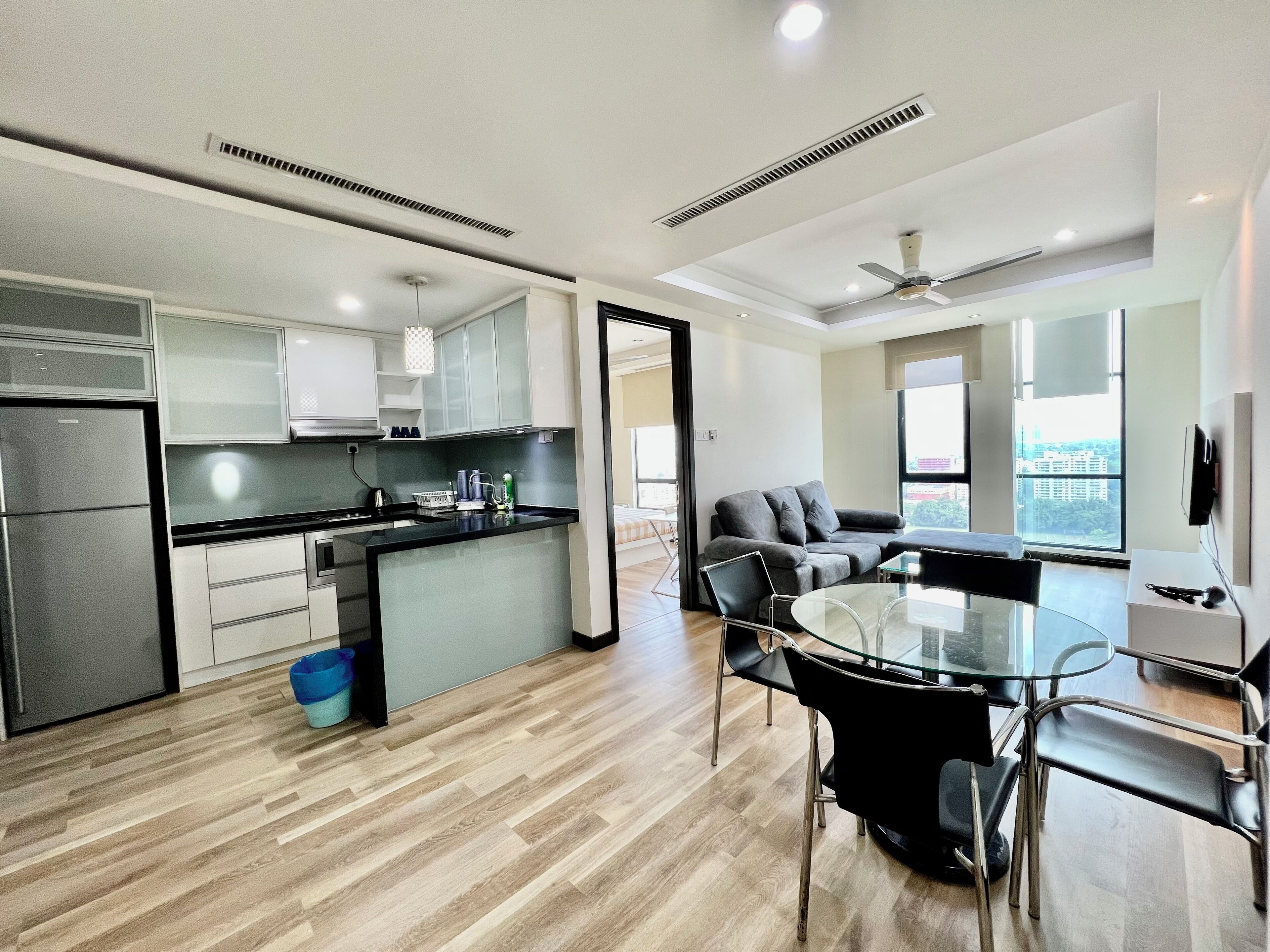A modern apartment with a kitchen, dining area, and living space.
