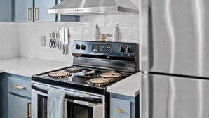 A modern kitchen with a stainless steel stove, a built-in oven, and a refrigerator. - Modern craftsman home close to all Garibaldi has to offer. Dog Friendly! (Rockaway Beach)