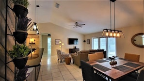 Relax in this stylish living space with a dining area, seating area, and kitchen.