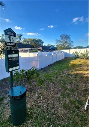 A designated area for pet owners to clean up after their dogs, complete with a trash bin.
