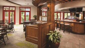 A spacious bar area with wooden furniture and a large potted plant. - Marriott Shadow Ridge at Palm Desert, CA (Palm Desert)