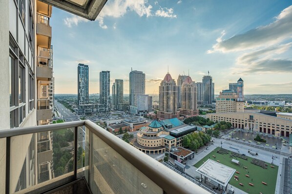 A high-rise building with a view of a cityscape, including several tall buildings and a central plaza with a dome structure. - Duke Of York Boutique Suites (Mississauga)