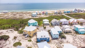 A coastal residential area with houses, a beach, and the ocean. - Dandy Sandy: Sleeps 24 - Pets - Pools - Hot Tubs (Gulf Shores)