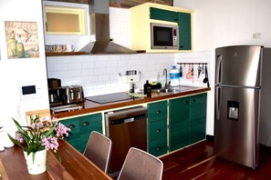 Enjoy meal preparation and dining in this well-equipped kitchen with a refrigerator, microwave, and dishwasher.