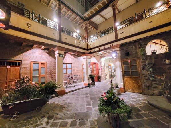 Stroll through this serene courtyard, surrounded by lush greenery and traditional architecture.