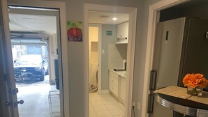 A kitchen with a refrigerator, a sink, and a dining area with stools. - 2 Bedroom with 2 Ensuite Unit in the heart of Richmond HIll. (Richmond Hill)