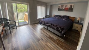 A bedroom with a bed, a desk, a chair, a nightstand, and a door leading to a balcony. - 2 Bedroom with 2 Ensuite Unit in the heart of Richmond HIll. (Richmond Hill)