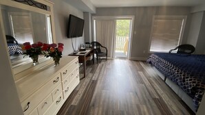 A bedroom with a bed, a dresser, a desk, a chair, a television, and a view of the outdoors. - 2 Bedroom with 2 Ensuite Unit in the heart of Richmond HIll. (Richmond Hill)