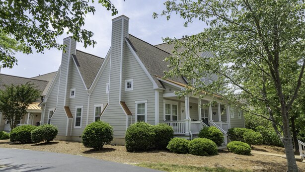 A two-story house with a gabled roof, a front porch, and a chimney. - Spinnaker Resorts and
Cottages at King's Creek Resorts (Williamsburg)