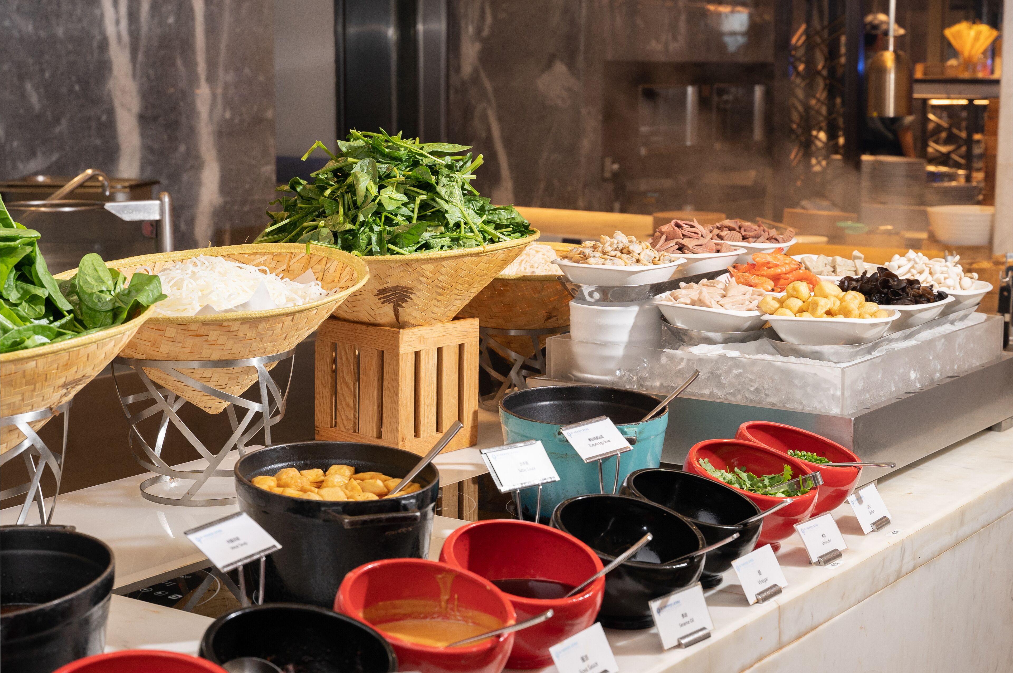 A buffet with various food items and condiments.