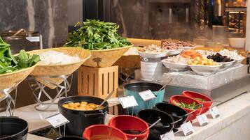 A buffet with various food items and condiments.