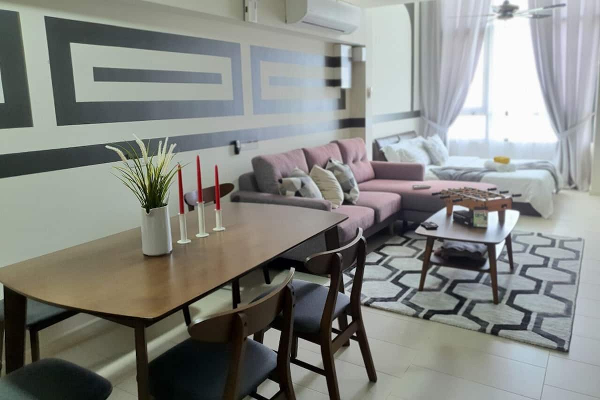A modern living room with a dining area, a sofa set, and a small table with a board game.