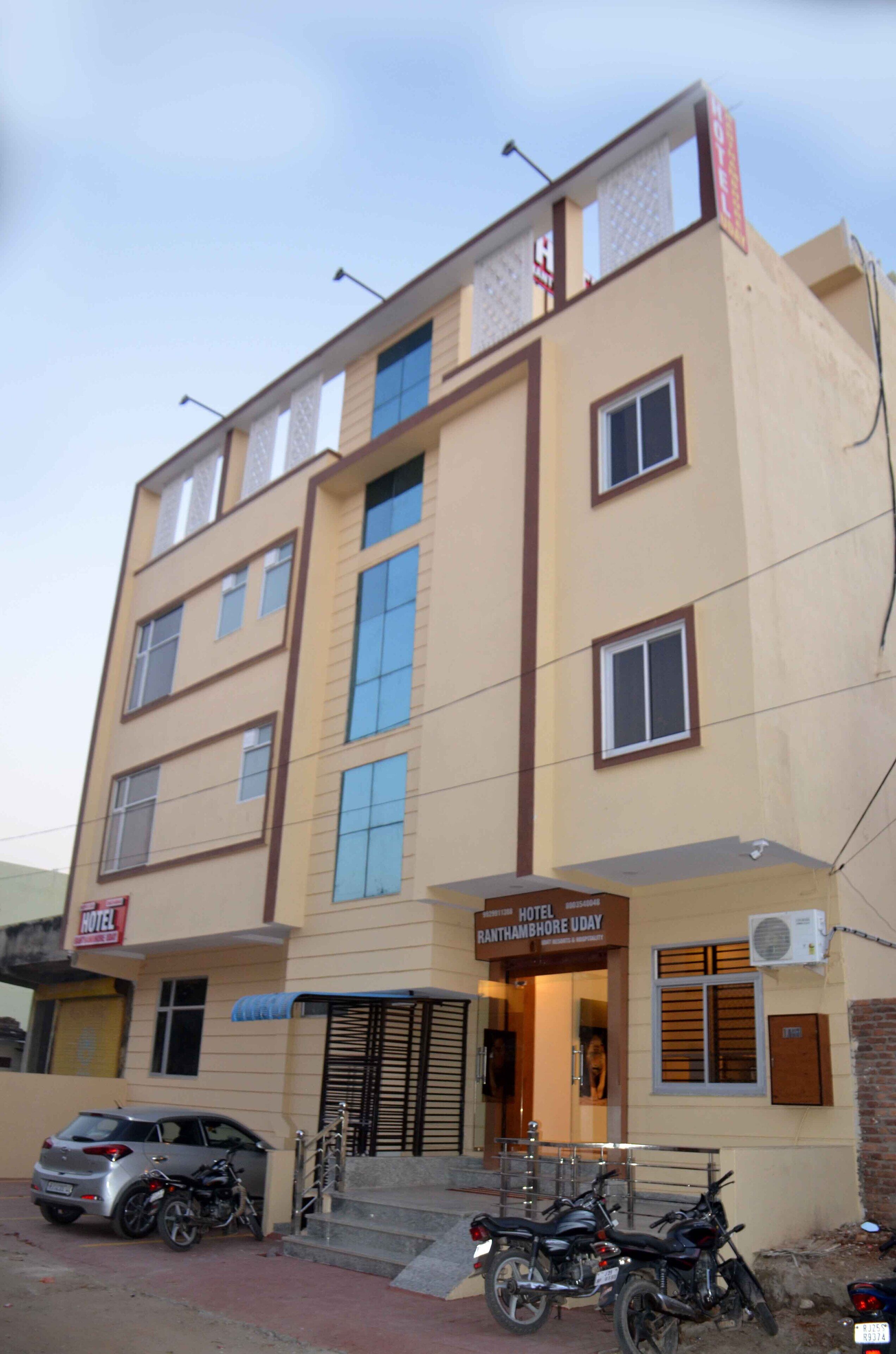 A multi-story hotel with a sign indicating it is the "Hotel Ranthambore Uday."