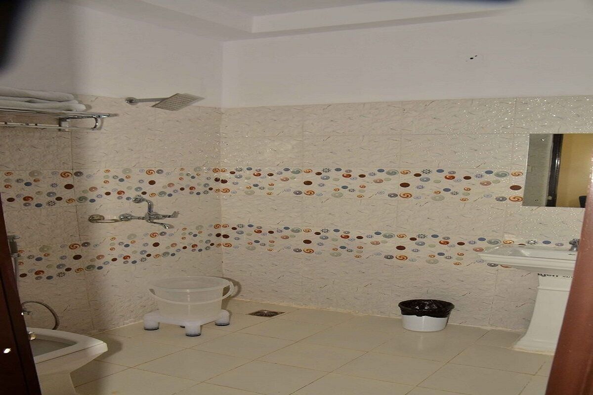A bathroom with a shower, toilet, and sink.