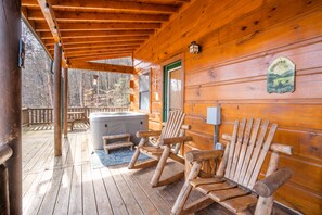 A wooden deck with Adirondack chairs and a hot tub. - Bearway to Heaven #2 (Pigeon Forge)