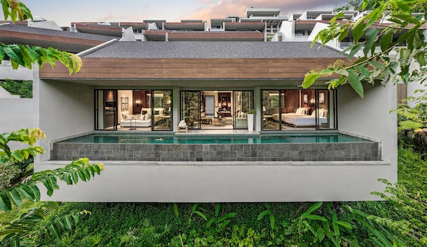 A modern house with a swimming pool, large windows, and a garden. - Anantara Ubud Bali Resort (Payangan)