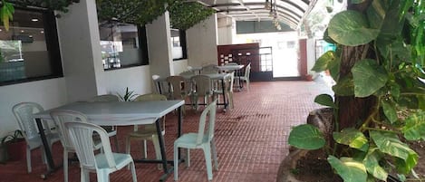 A restaurant with indoor seating, tables, and chairs.