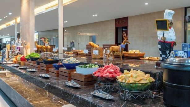 A buffet area with various food items and a chef statue. - Days Hotel by Wyndham Hunan Zhangjiajie (Zhangjiajie)