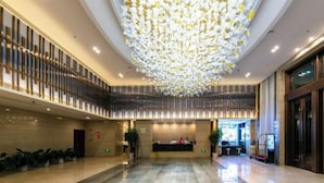 A spacious lobby with a reception desk, a high ceiling with a decorative hanging element, and a polished marble floor. - Days Hotel by Wyndham Hunan Zhangjiajie (Zhangjiajie)