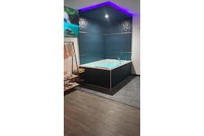 A modern bathroom with a freestanding bathtub, a shower area, and a vanity with a mirror.