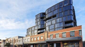 A modern hotel with a brick facade and large windows.
