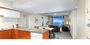 A modern kitchen with granite countertops, wooden cabinets, and a built-in dishwasher.