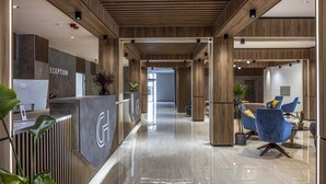A modern reception area with a reception desk, a Dell computer, and a reception counter.
